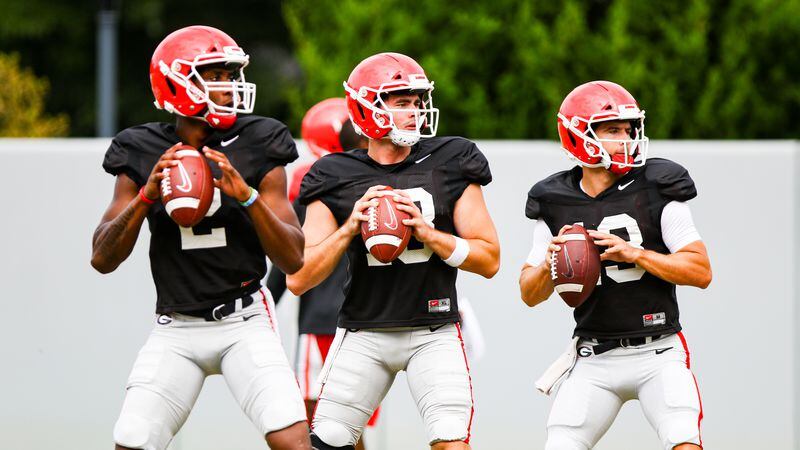 Georgia quarterbacks D'Wan Mathis (2), JT Daniels (18) and Stetson Bennett (13) get in some throwing time during the Bulldogs’ practice session Wednesday, Sept. 9, 2020, in Athens. (Tony Walsh/UGA Sports)