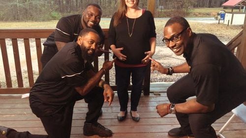 Mary Hall, who is expecting twins, poses with former NFL players who came bearing gifts donated by Kids II. Hall’s husband, Jonathon, was among members of the Georgia National Guard being deployed to Afghanistan. CONTRIBUTED