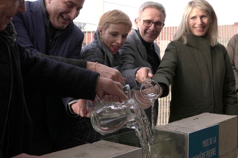 Stephane Blanchet, mayor of the Paris-region town of Sevran,second from left, and other officials pour jugs of water at a Jan. 24, 2024, ceremony to celebrate the start of building works to accommodate a new swimming pool in Sevran. The town of 51,000 people in the Seine-Saint-Denis region north of Paris is inheriting one of the pools that will be used for the Olympic and Paralympic Games in Paris this summer. (AP Photo/John Leicester)
