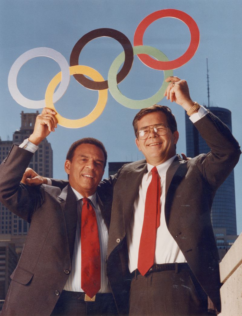 Billy Payne and Andrew Young with Olympic rings and Atlanta skyline. Photo credit: Greg Foster/special.