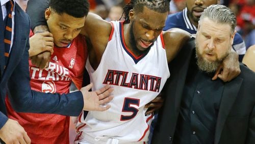 Kent Bazemore and a trainer help DeMarre Carroll off the court in Game 1 of the Eastern Conference Finals on Wednesday, May 20, 2015, in Atlanta. Curtis Compton / ccompton@ajc.com