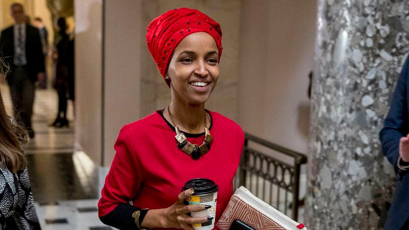In this Jan. 16, 2019 file photo, Rep. Ilhan Omar, D-Minn., center, walks through the halls of the Capitol Building in Washington. (AP Photo/Andrew Harnik)