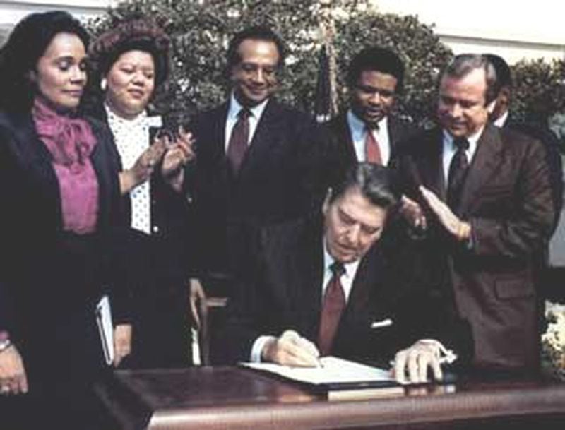 Photograph of President Ronald Reagan and the Signing Ceremony for Martin Luther King Holiday Legislation in 1983