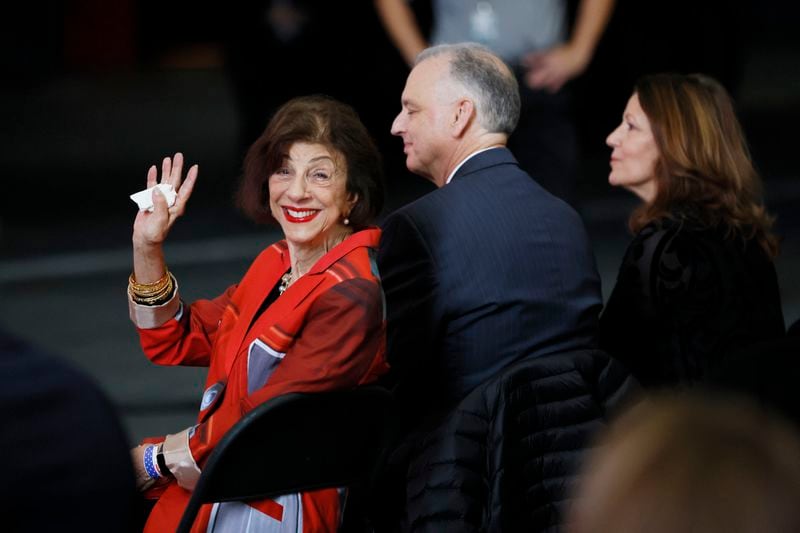 Barbara Dooley waves to guests as she is introduced during the plane dedication to honor UGA legend Vince Dooley on Tuesday at Hartsfield-Jackson International Airport. (Miguel Martinez / miguel.martinezjimenez@ajc.com)