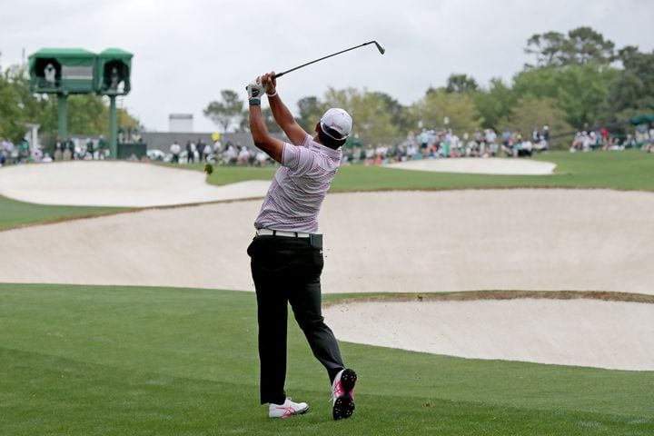 April 9, 2021, Augusta: Hideki Matsuyama hits his second shot on the eighteenth hole during the second round of the Masters at Augusta National Golf Club on Friday, April 9, 2021, in Augusta. Curtis Compton/ccompton@ajc.com