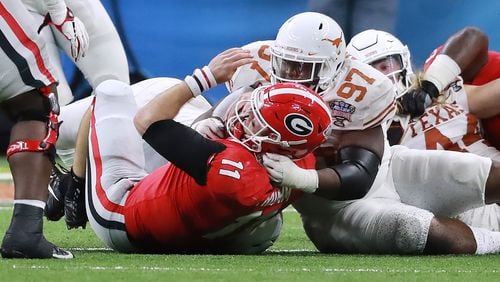 Georgia quarterback Jake Fromm is sacked by Texas defensive lineman Chris Nelson during the second half of the Sugar Bowl on Tuesday night in New Orleans.