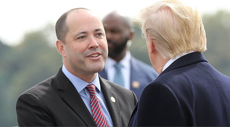 Attorney General Chris Carr greets then-President Donald Trump after he arrived at Dobbins Air Reserve Base in 2019. Carr is backing Trump's reelection bid.
