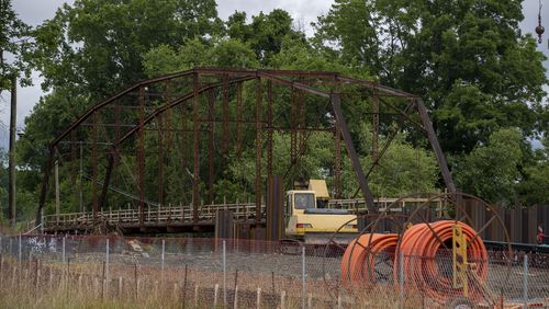 Rogers Bridge, located at Rogers Bridge Park was being dismantled and salvaged in Duluth in June. Ten tons of salvaged steel from Rogers Bridge was  evenly divided between Johns Creek and Duluth for each city to use or distribute to the public. (Alyssa Pointer / Alyssa.Pointer@ajc.com)