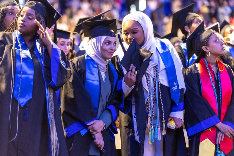 Georgia State University students Aaeshah Abdulla and Isatu Bah, who graduated last May, won't have to worry about tuition hikes.