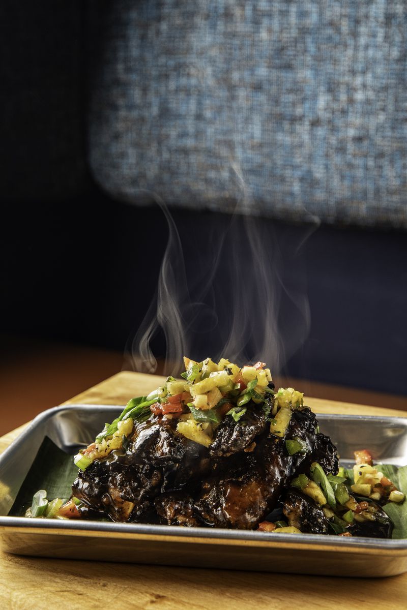 Jerk chicken wings are one of several Caribbean-influenced dishes on the menu at J’ouvert Caribbean Kitchen in Atlanta. / Courtesy of Bites & Bevs Media