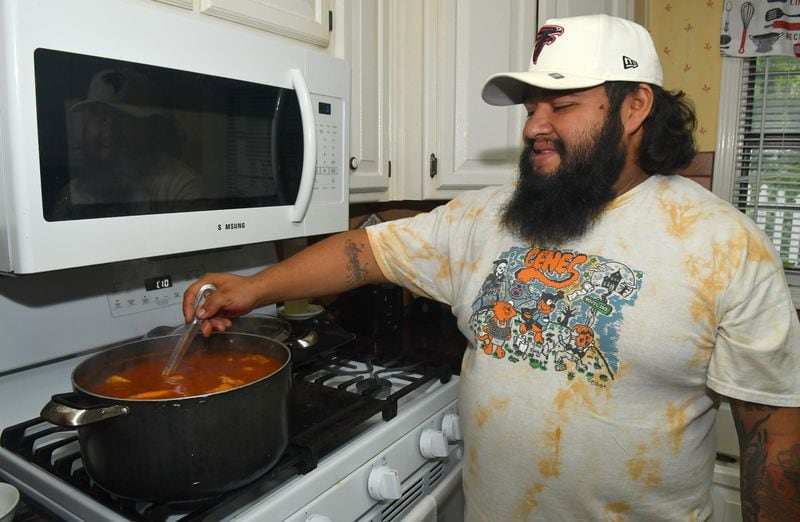 Mexico City native Arturo Justo prepares a pot of pozole rojo at his home in Lawrenceville. The Mexican soup is one that his mother prepared for him throughout his childhood. (CHRIS HUNT FOR THE ATLANTA JOURNAL-CONSTITUTION)