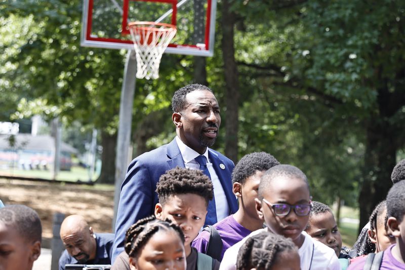 Atlanta Mayor Andre Dickens takes a photo with students in the Camp Best Friends Summer Program following a ribbon cutting ceremony for the new basketball court at Pittman Park on Wednesday, July 13, 2022. The court  will be a part of his Midnight Basketball initiative created to give youth a place to spend time. (Natrice Miller/natrice.miller@ajc.com)