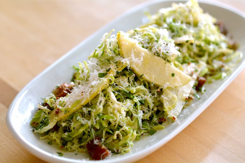 Shaved Brussels Sprouts and Apple Salad With Warm Bacon Vinaigrette, Parmesan, Pine Nuts, and Pancetta is from chef Doug Turbush, owner of Seed Kitchen & Bar, Stem Wine Bar, and Drift Fish House & Oyster Bar. Courtesy of Jeff Moore