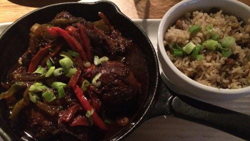 The brown-stew chicken with rice and peas is a standout at Ms. Icey’s Kitchen & Bar in Decatur. CONTRIBUTED BY WENDELL BROCK