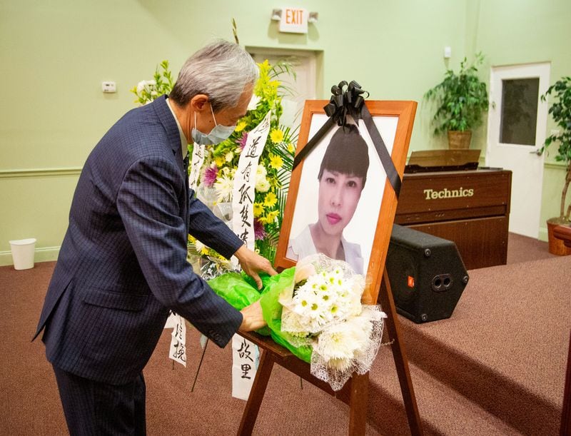 Byron Chan organizes flowers before the start of the funeral for Daoyou Feng in Norcross on Sunday, April 4, 2021. The 44-year-old was among the eight people slain in metro Atlanta spa shootings last month. She was from China and had no known family in the U.S. (Photo: Steve Schaefer for The Atlanta Journal-Constitution)