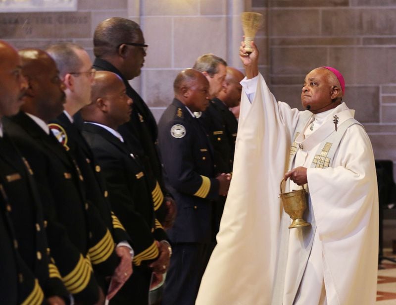  Archbishop Wilton Gregory offers a blessing to first responders at the Cathedral of Christ the King.  BOB ANDRES  / BANDRES@AJC.COM