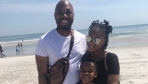 Lashad Lewis (left) with his fiance Brandy Gilkey and her son, Christian McDonald. Gilkey, who was pregnant, and McDonald were killed in a head-on collision in Clayton County that also seriously injured Lewis, who was driving.