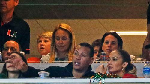 A-Rod and J-Lo watched the U win Saturday. (AP Photo/Wilfredo Lee)