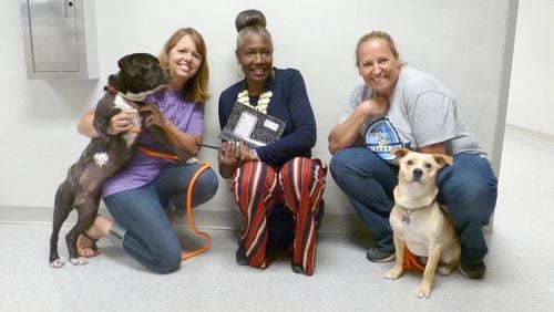 From left to right are Tammy Turley, Brenda Williams and Emily Shervin pose with Amaya and Wagner, two dogs that recently graduated from the Mostly Mutts University prison program.