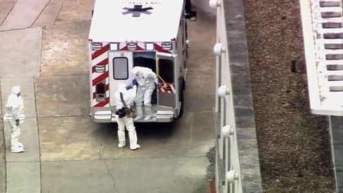 An ambulance arrives with Ebola victim Dr. Kent Brantly, right, at Emory University Hospital, Saturday. WSB-TV photo.