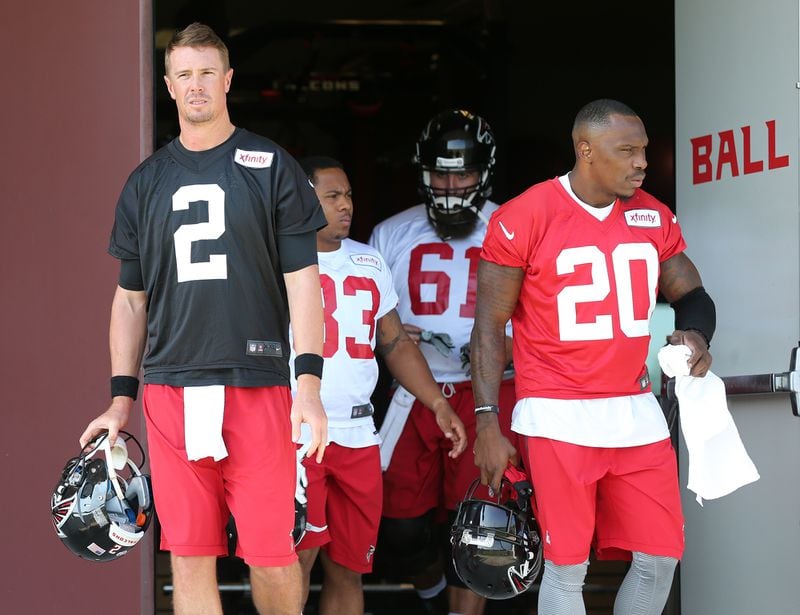 Falcons quarterback Matt Ryan (left) and cornerback Phillip Adams (right) take the field for the first day of training camp on Friday, July 31, 2015, in Flowery Branch. Adams has been identified as the gunman who killed five people in South Carolina on April 7, 2021, before turning the gun on himself. Curtis Compton / ccompton@ajc.com