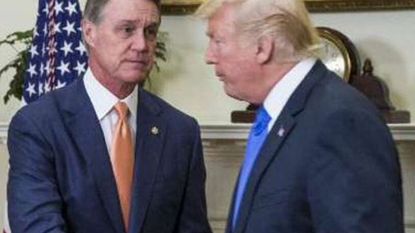 U.S. Sen. David Perdue, left, was one of the first senators to endorse Donald Trump’s presidential campaign and is now among his most vocal defenders. It’s made the Georgian one of the most important voices in Washington in the immigration debate.