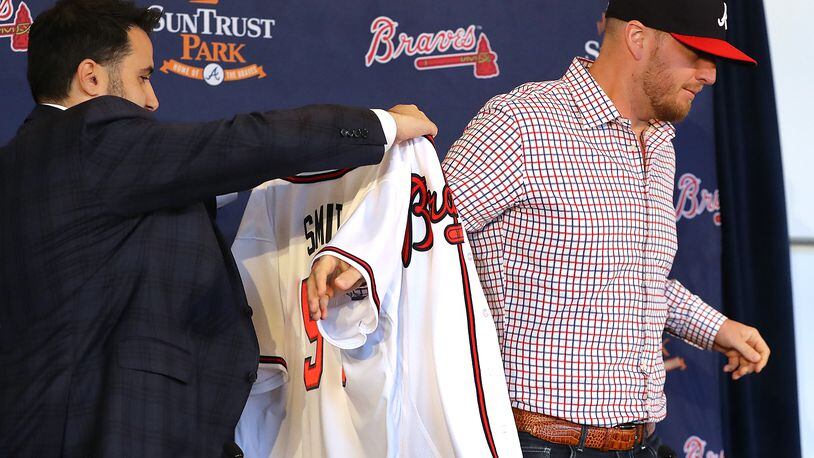 Braves General Manager Alex Anthopoulos gives left-handed pitcher Will Smith his new jersey.