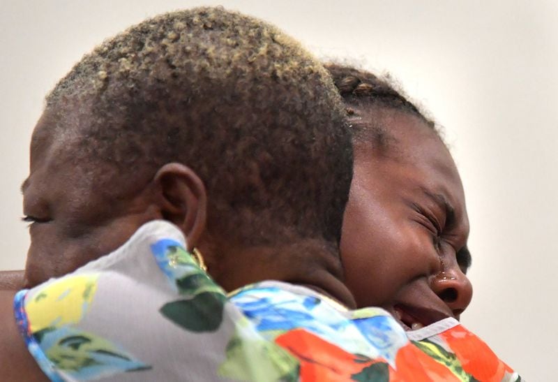 Family members of Timothy Coggins embrace after the murder trial of Franklin Gebhardt at the Spalding County Courthouse on June 26, 2018. 