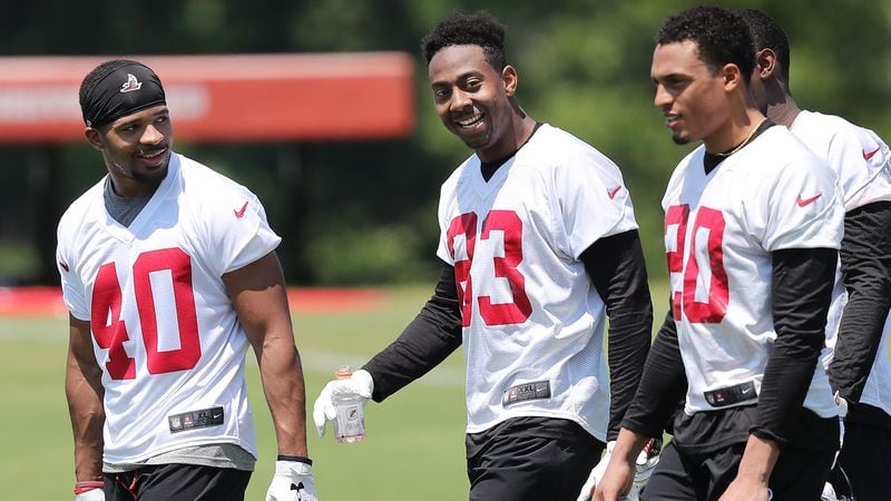 May 11, 2018 Flowery Branch: Atlanta Falcons safety Tere Calloway (from left), wide receiver Russell Gage, and cornerback Isaiah Oliver walk of the field at the end of the first day of rookie-mini-camp on Friday, May 11, 2018, in Flowery Branch.  Curtis Compton/ccompton@ajc.com