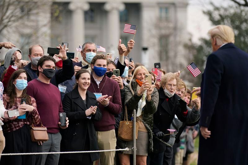Supporters greeet President Donald Trump as he walks on the South Lawn of the White House in Washington, Saturday, Dec. 12, 2020, before boarding Marine One. Trump is en route to the Army-Navy Game at the U.S. Military Academy in West Point, N.Y. (AP Photo/Patrick Semansky)