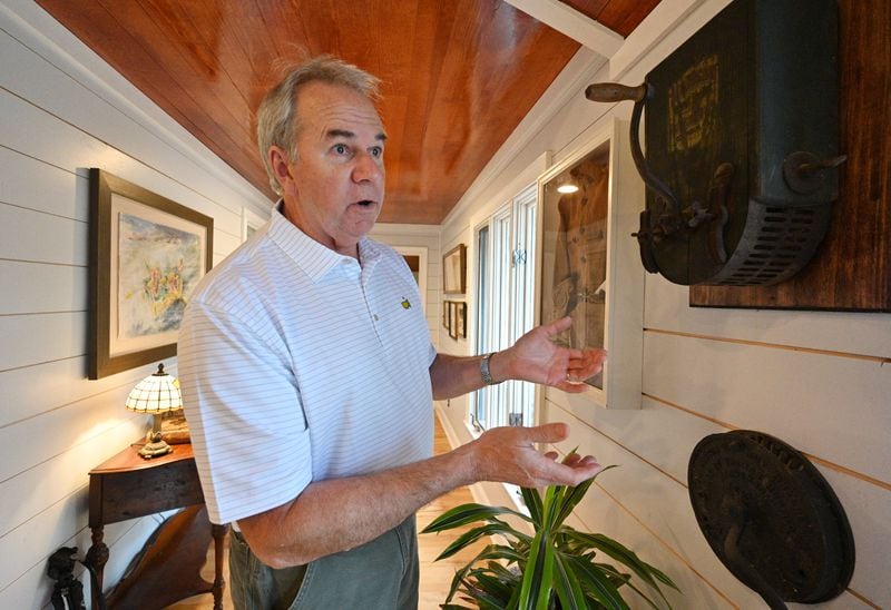 Former Tom's Foods general manager Jack Warden shows an old nut sheller machine from Tom's Foods at his home in Midland on Friday, Feb. 26, 2021. He spent 31 years working at the Columbus plant. (Hyosub Shin / Hyosub.Shin@ajc.com)