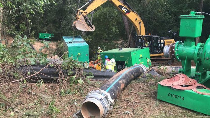 DeKalb Watershed Management spent days fixing this sewage spill on Eagle’s Beek Circle near Stonecrest in August 2017. County officials say that new leadership, debris removal and increased inspections helped reduced sewer spills this year. AJC file photo