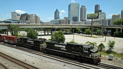 A Norfolk-Southern train travels south close to the Mitchell Street bridge. The Norfolk-Southern route runs north-south through downtown beneath the Georgia World Congress Center (GWCC), through the Gulch, and then onward to parallel MARTA’s Red/Gold lines south of downtown. Residents in southeast Atlanta have complained of long wait times at railway crossings in their neighborhoods. Jason Getz for The Atlanta Journal-Constitution
