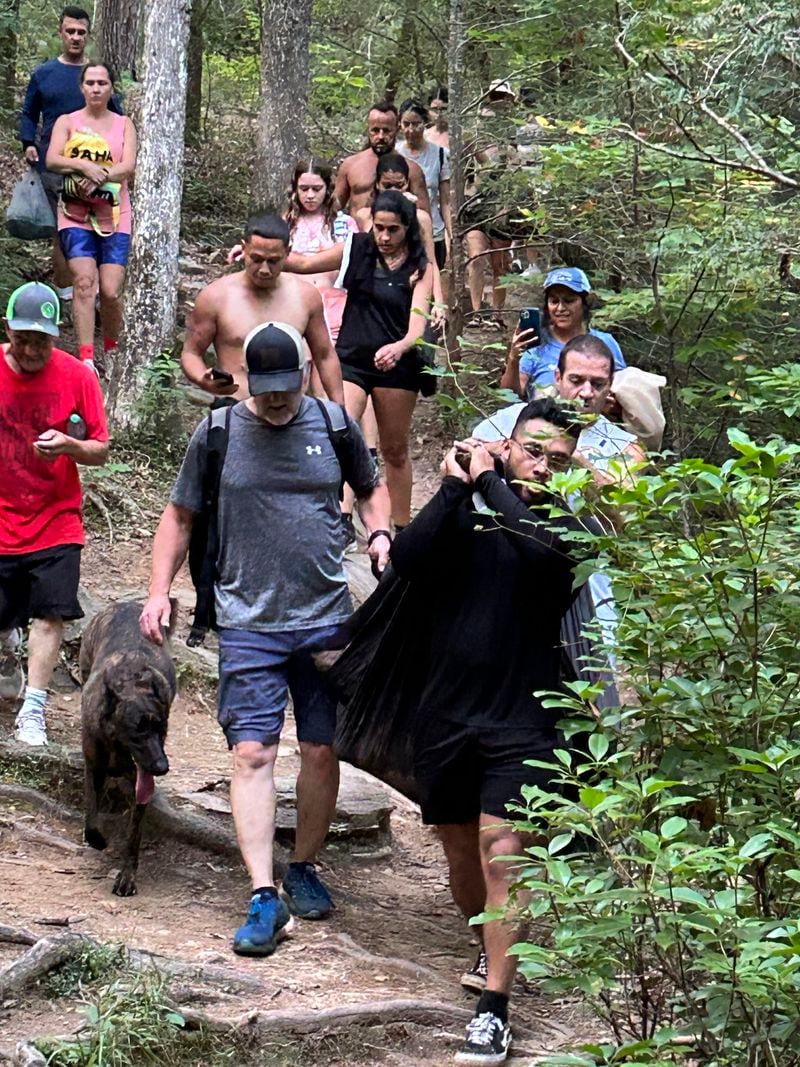 A group of strangers helped the Santanas carry their dog down the mountain when the pup could no longer walk. Courtesy of Cheryl Hite
