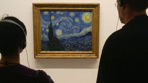 Visitors take a look at Vincent van Gogh's 'Starry Night' at the MoMA exhibit, on March 24, 2004 in Berlin, Germany. The exhibit, which opened February 20 and runs through December 14, has been a tremendous success and is averaging between 5,000 and 7,000 visitors a day. Highlights of the exhibit, all of which come from the Museum of Modern Art in New York, include works by Pablo Picasso, Vincent van Gogh, Salvador Dali, Jackson Pollock and Roy Lichtenstein. (Photo Sean Gallup/Getty Images)