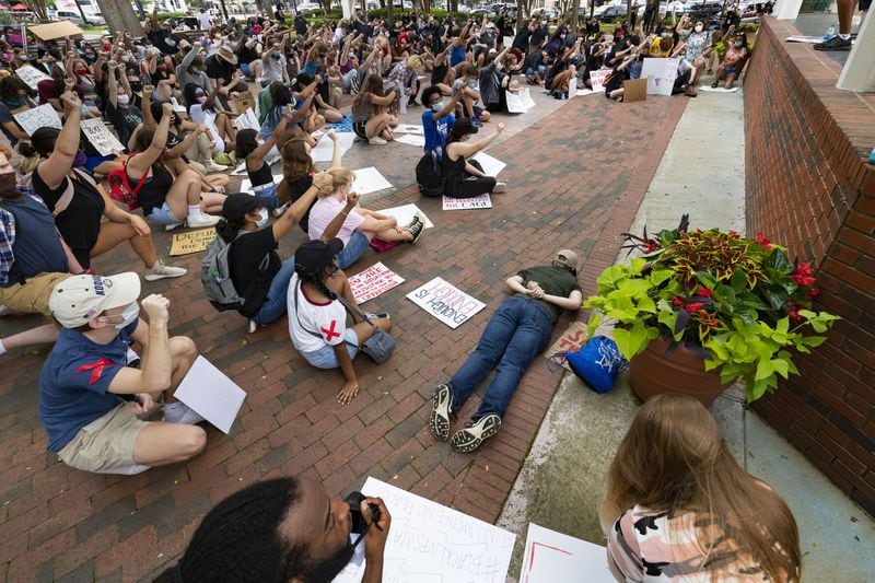 Owen Ollis of East Cobb lies on his stomach with hands behind his back in similar fashion to Georgia Floyd’s position as he and others pause in silence for 8 minutes and 46 seconds during a protest over the recent Minneapolis police killing of George Floyd, held Wednesday, June 3, 2020, in Marietta, Ga. 8 minutes and 46 seconds is the amount of time the officer involved handcuffed and pinned Floyd to the ground with his knee which is allegedly the cause of Floyd’s death. JOHN AMIS FOR THE ATLANTA JOURNAL-CONSTITUTION