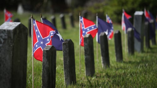 Confederate flags fly over the graves of Confederate soldiers buried in Magnolia Cemetery on July 14, 2015 in Charleston, South Carolina. (Photo by John Moore/Getty Images)