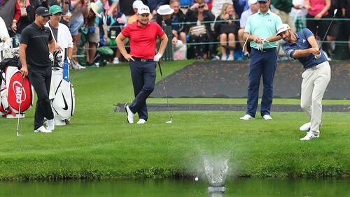 April 3, 2017, Augusta: Brooks Koepka (from left), Tyrell Hatton, and Gary Woodland look on as Dustin Johnson skips his ball across the pond to the 16th green during their practice round at Augusta National Golf Club on Monday, April 3, 2017, in Augusta. Curtis Compton/ccompton@ajc.com