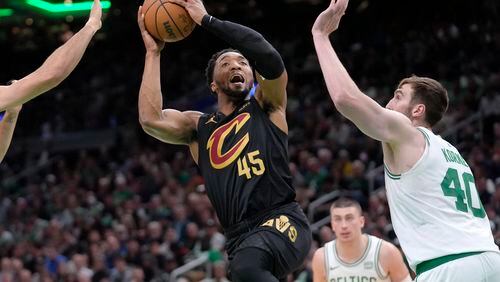 Cleveland Cavaliers guard Donovan Mitchell (45) shoots as Boston Celtics center Luke Kornet (40) defends during the second half of Game 2 of an NBA basketball second-round playoff series Thursday, May 9, 2024, in Boston. (AP Photo/Steven Senne)