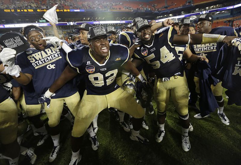 Georgia Tech defensive lineman Francis Kallon (92) and linebacker Quayshawn Nealy (54) celebrate after winning the Orange Bowl NCAA college football game against Mississippi State , Wednesday, Dec. 31, 2014, in Miami Gardens, Fla. Georgia Tech defeated Mississippi State 49-34. (AP Photo/Lynne Sladky) "So are you still not impressed?" (Lynne Sladky/AP photo)