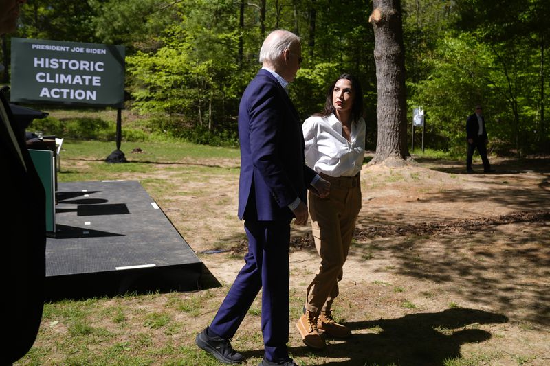 President Joe Biden, left, and Rep. Alexandria Ocasio-Cortez, D-N.Y. are pictured after Biden spoke at Prince William Forest Park on Earth Day, Monday, April 22, 2024, in Triangle, Va. Biden announced $7 billion in federal grants to provide residential solar projects serving low- and middle-income communities and expanding his American Climate Corps green jobs training program. (AP Photo/Manuel Balce Ceneta)