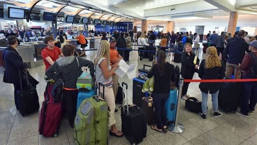 April 7, 2017 Atlanta - Delta passengers wait in line in hopes of catching their flight out of Hartsfield-Jackson Atlanta International Airport on Friday, April 7, 2017. Dozens of long lines with thousands of passengers trying to get help extended through the terminal at Hartsfield-Jackson International Airport, as the fallout of Delta Air Linesâ flight cancellations extended into a third day. HYOSUB SHIN / HSHIN@AJC.COM