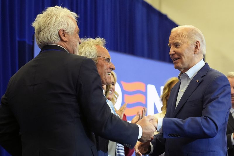 President Joe Biden, from right, greets Joe Kennedy III, Maxwell Kennedy Sr., and members of the Kennedy family at a campaign event, Thursday, April 18, 2024, in Philadelphia. (AP Photo/Alex Brandon)