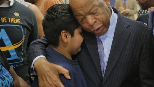 At the end of the program John Lewis spent time with students for hugs and taking photos, including Hugo Hernandez-Cruz. Lewis was on hand, along with Atlanta Public Schools Superintendent Meria Carstarphen for the first day at the new John Lewis Invictus Academy. BOB ANDRES /BANDRES@AJC.COM