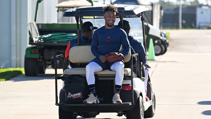 Atlanta Braves second baseman Ozzie Albies smiles as he rides on a golf cart on the first of the Braves pitchers and catchers report to spring training at CoolToday Park, Monday, Feb. 13, 2023, in North Port, Fla.. (Hyosub Shin / Hyosub.Shin@ajc.com)