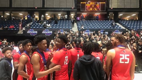 The Alexander basketball team celebrates with their fans after winning the Class 6A championship, a 64-42 win over Lee County on March 10, 2023.