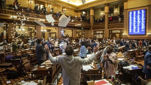 Members of the House of Representatives throw paper on the final day of a legislative session. They will be back Monday to begin a new 40-day session. (Alyssa Pointer / Alyssa.Pointer@ajc.com)