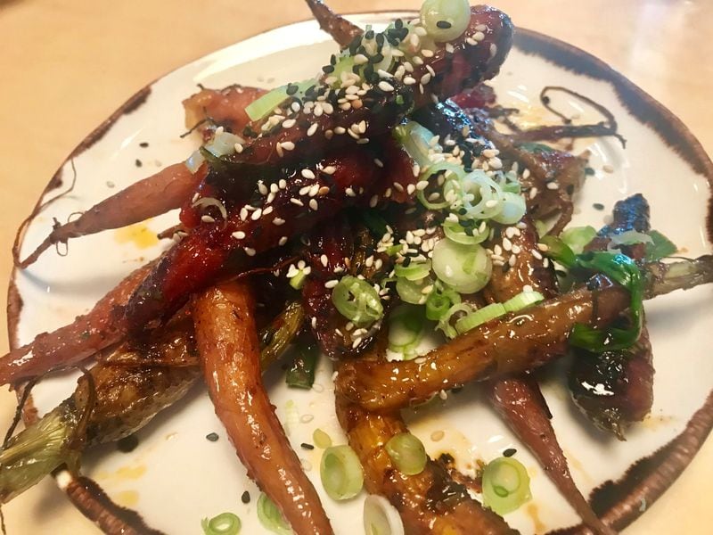 “I still can’t get the roasted baby carrots out of my mind,” writes Atlanta Journal-Constitution food and dining editor Ligaya Figueras, about a dish she ate at new Alpharetta restaurant Holmes. “It felt original and yet wholly familiar and soul satisfying. And, it didn’t take a freeze-dryer or a centrifuge to make it.” LIGAYA FIGUERAS / LFIGUERAS@AJC.COM