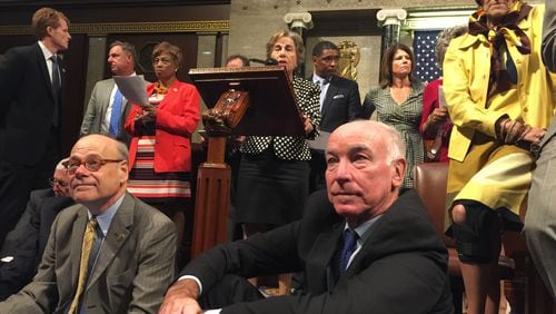 This photo provided by Rep. Chellie Pingree, D-Maine shows Democrat members of Congress, including, front row, from left, Rep. Steve Cohen, D-Tenn., Rep. Joe Courtney, D-Conn., and Rep. Rosa DeLauro, D-Conn., participate in sit-down protest seeking a a vote on gun control measures, Wednesday, June 22, 2016, on the floor of the House on Capitol Hill in Washington. (Rep. Chellie Pingree via AP)