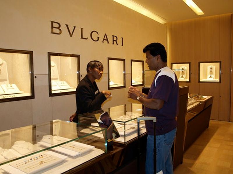 The new Bulgari shop on Concourse A of Hartsfield-Jackson International Airport sells luxury items, like $290 rings and $3,700 bracelets. In this photo, sales clerk D. Bullard talks with Atlanta resident Reddy Gaddam who was on his way to India.